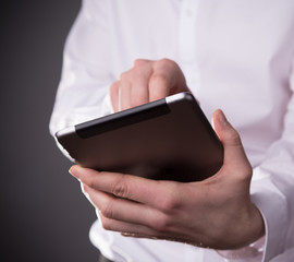 Hand touching digital tablet