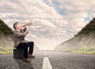 businessman shouting with a megaphone