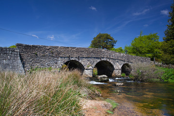 Fototapeta na wymiar The ancient clapper bridge at Postbridges in Dartmoor National P