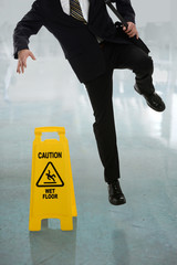 Businessman Slipping on Wet Floor