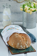 Rustic bread on a white wooden board