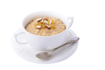 Oatmeal porridge with almonds and raisins on white background