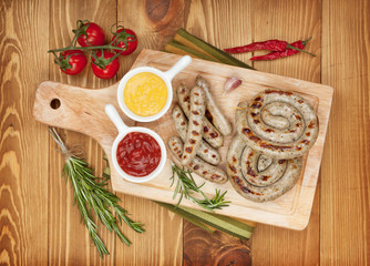 Grilled sausages with ketchup and mustard