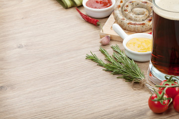 Grilled sausages with ketchup, mustard and mug of beer