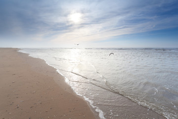 sunshine over sand beach in North sea