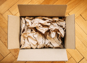 Cardboard box filled with shipping packaging paper
