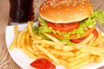 Big and tasty hamburger and fried potatoes