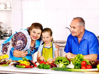 Family with child cooking at kitchen.