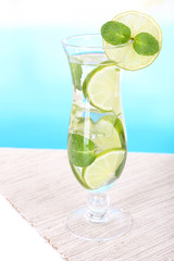 Glass of cocktail with lime and mint