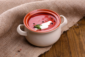 Tasty tomato soup on wooden table