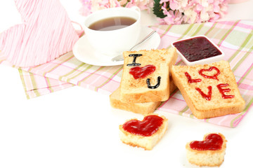 Delicious toast with jam and cup of tea on table close-up