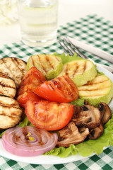 Delicious grilled vegetables on plate on table close-up