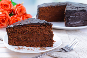 Delicious chocolate cake on plate on table close-up