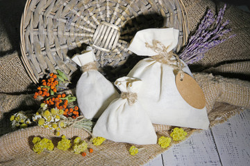 Textile sachet pouch with dried flowers, herbs and berries