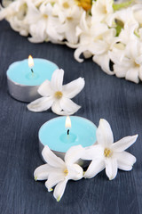 Fototapeta na wymiar White hyacinth with candles on wooden background