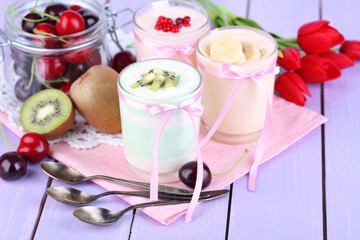 Delicious yogurt with fruits tastes in glasses and fresh fruits