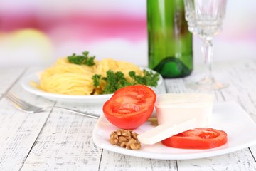 Composition with tasty spaghetti, grater, cheese, wine bottle