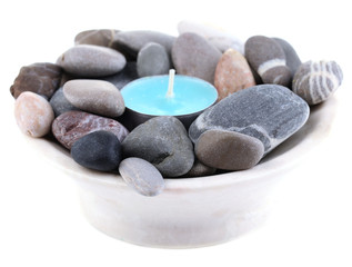 Spa stones with candle isolated on white