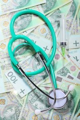 cost of health care: stethoscope on polish money