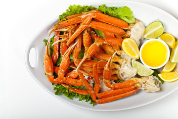 Crab legs with fresh lemon and butter sauce. Selective focus