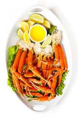 Crab legs with fresh lemon and butter sauce. Selective focus