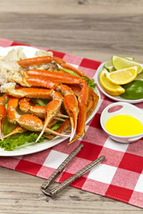 Snow Crab legs with fresh lemon slices and butter sauce