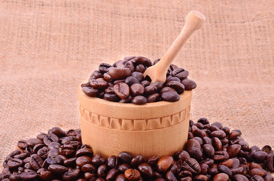 Pile of coffee beans on sackcloth background