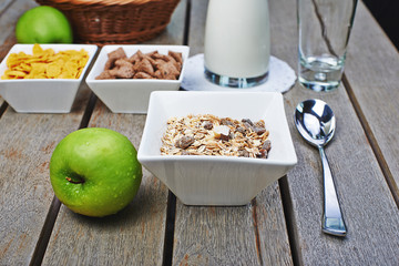 Tasty breakfast of muesli, fresh milk and apples