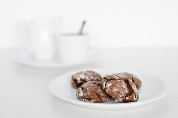 Chocolate crinkles cookies with coffee, white background