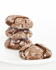 Stacked chocolate cookies on white background. Chocolate crinkle