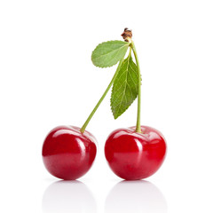 Fototapeta na wymiar Red cherry with leaves isolated on white