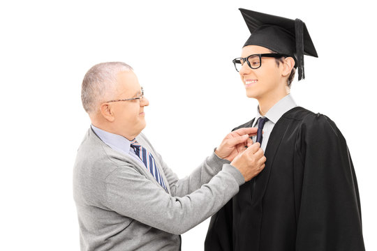 Proud Father Preparing His Son For Graduation