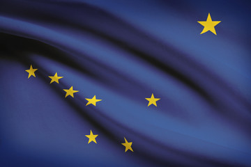 Series of ruffled flags of US states. State of Alaska.