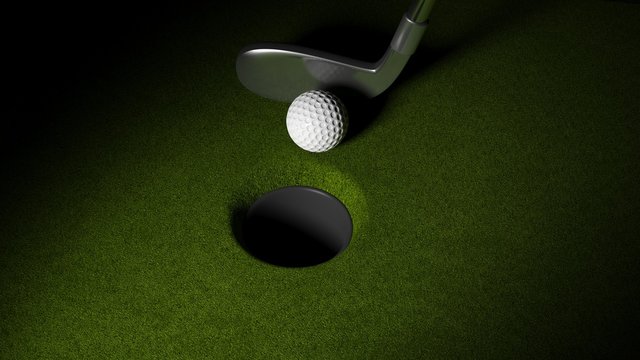 Golf ball with club on putting greens with hole