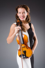 Woman artist with violin in music concept