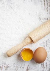 Flour and eggs on a wooden board