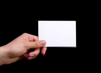 Female Hand Holding White Blank Card on Black Background