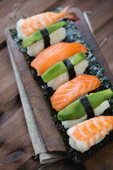 Sushi set on a rustic wooden board, vertical shot