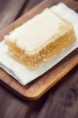 Close-up of a honeycomb, rustic wooden background, studio shot