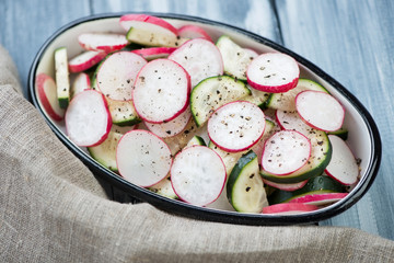 Salad with fresh radish and cucumber, close-up, studio shot