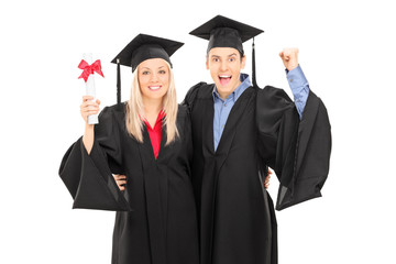 Male and female student celebrating graduation