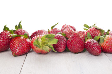 ripe strawberries on white table,border, isolated