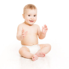 Baby smile, happy kid boy in diaper sitting white background © inarik