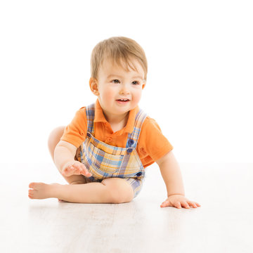 Child happy smiling, small one year boy crawling over white