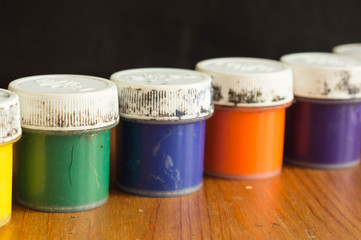Some old cans with gouache of different color