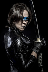 Fototapeta na wymiar Danger, Woman with katana sword in latex costume