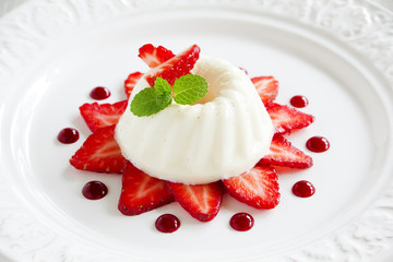 Strawberry blancmange garnished with fresh strawbe