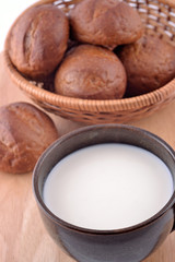 Ceramic cup with milk and bread