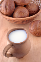 Ceramic jug with milk and bread