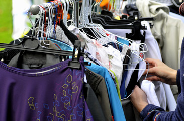 clothes on a rack in a flea market - 62682124
